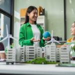 Businessman team brainstorming using tablet, laptop computer for working technology and business,  Renewable energy-based green businesses and global warming. Reduce CO2 emission.