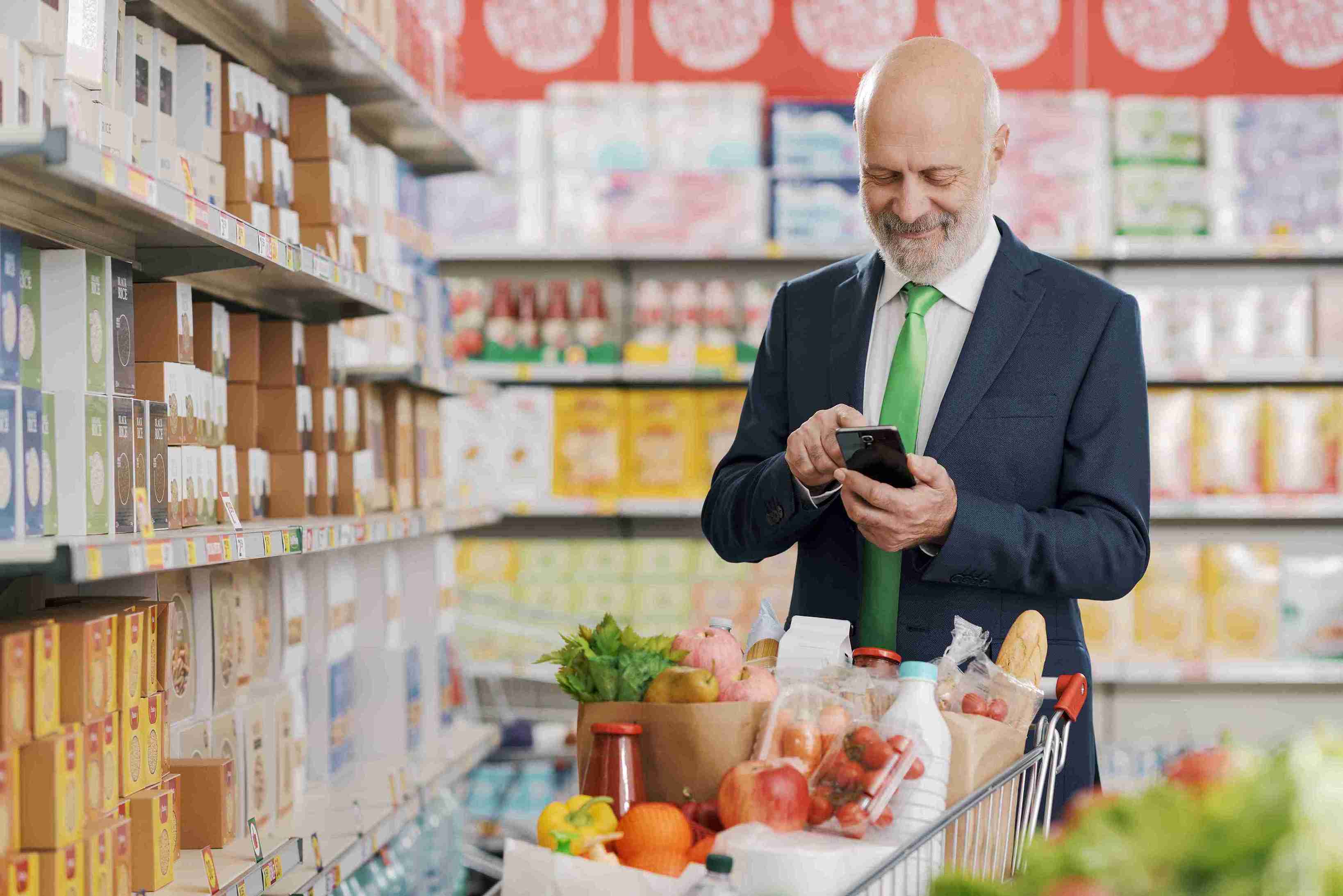 businessman-using-smartphone-supermarket_11zon