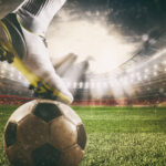 Close up of a soccer striker ready to kicks the ball at the stadium