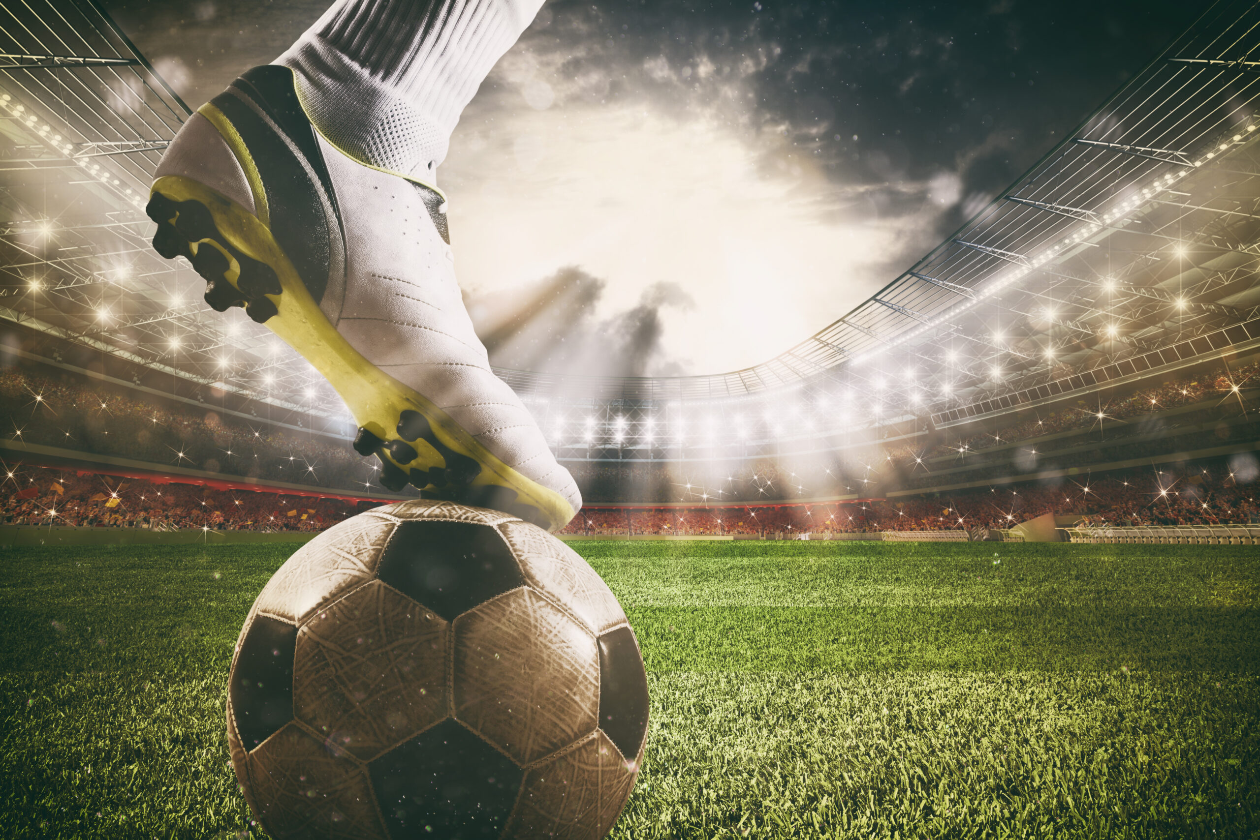Close up of a soccer striker ready to kicks the ball at the stadium