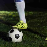 crop-legs-stepping-soccer-ball_11zon
