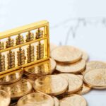 golden-abacus-with-chinese-rmb-gold-coins-as-background_11zon