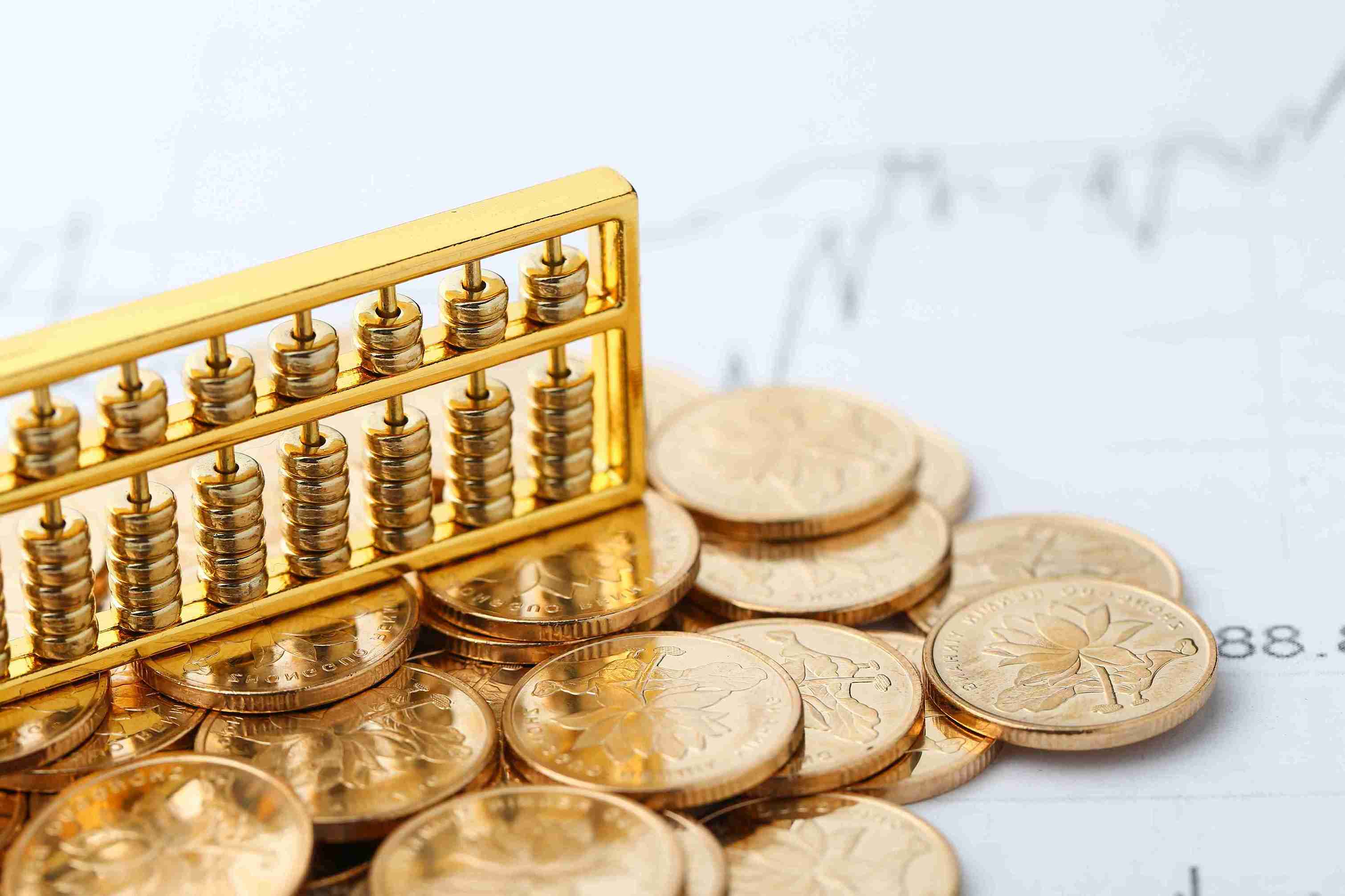 golden-abacus-with-chinese-rmb-gold-coins-as-background_11zon