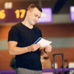 handsome-man-standing-airport_11zon