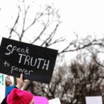 person-holding-with-text-placard-city-protest_11zon